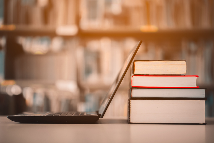 Bøker og pen pc på et bibliotek